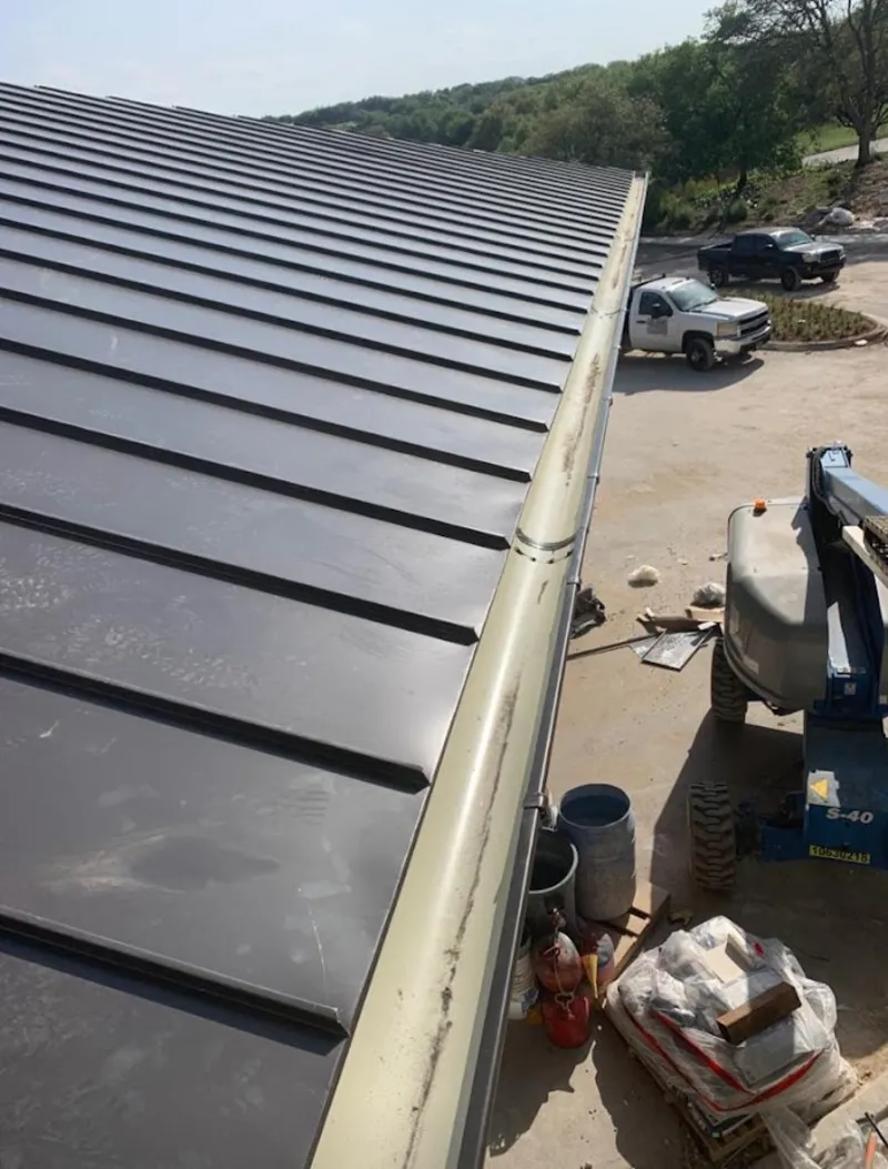 Standing seam panel and gutter detail on a metal roofing jobsite in Georgetown